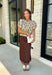 A classic print meets an effortlessly feminine silhouette in this charming knit cardigan! Featuring a soft tan knit with a playful brown polka dot print, this button-down cardigan is finished with sweet puff sleeves for an elevated touch. Whether worn buttoned as a top or layered over your favorite basics, this versatile piece is perfect for everything from office days to coffee dates and weekend outings.