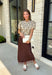 A classic print meets an effortlessly feminine silhouette in this charming knit cardigan! Featuring a soft tan knit with a playful brown polka dot print, this button-down cardigan is finished with sweet puff sleeves for an elevated touch. Whether worn buttoned as a top or layered over your favorite basics, this versatile piece is perfect for everything from office days to coffee dates and weekend outings.