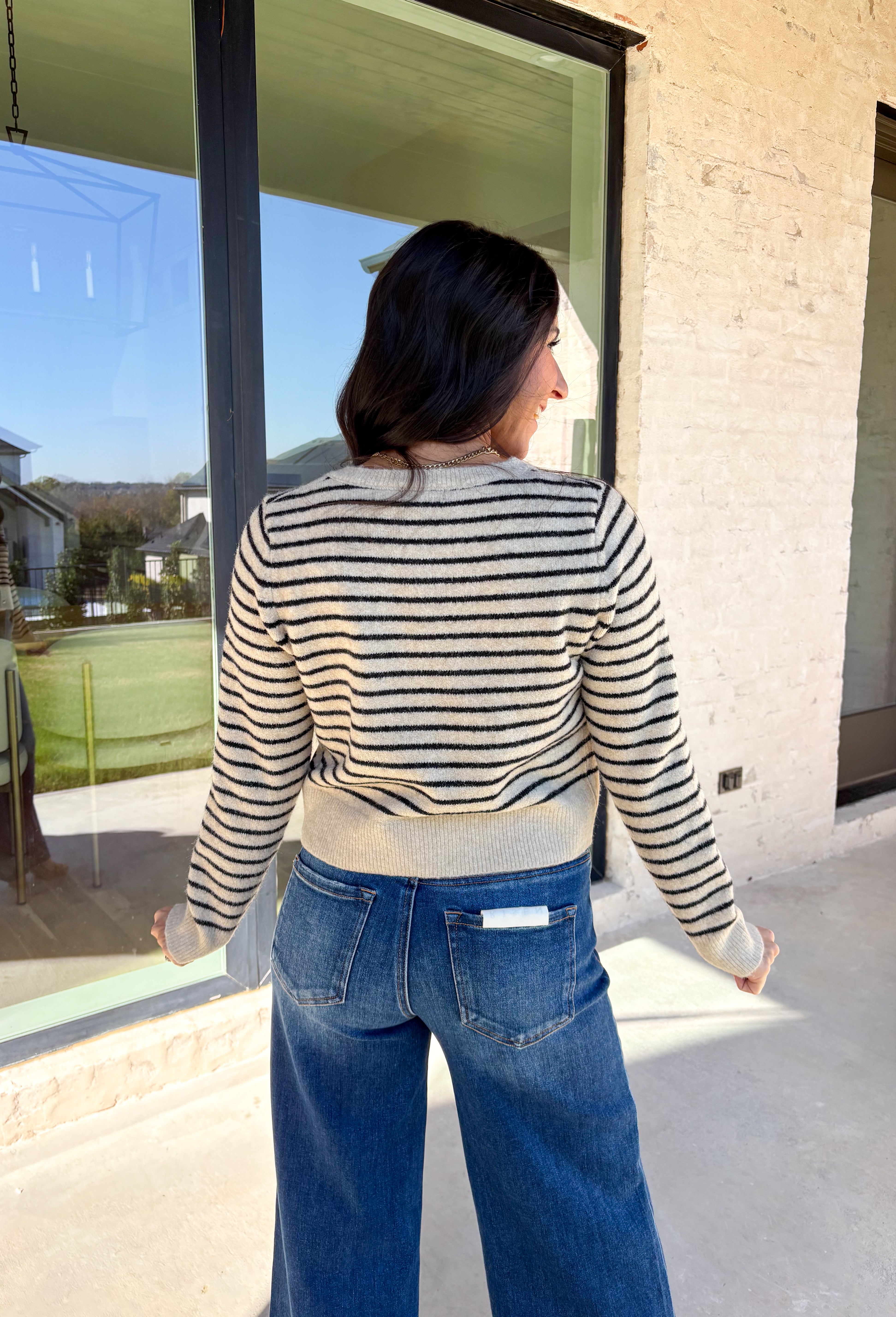 Chic, cozy, and perfect for winter layering, this taupe button-down cardigan by Paper Moon brings a modern twist to a classic stripe. Featuring black stripe detailing and gleaming gold buttons, this cropped knit adds just the right amount of polish to your cold-weather wardrobe. Soft, warm, and easy to style, it’s the ideal piece for dressing up denim or layering over your favorite winter basics.