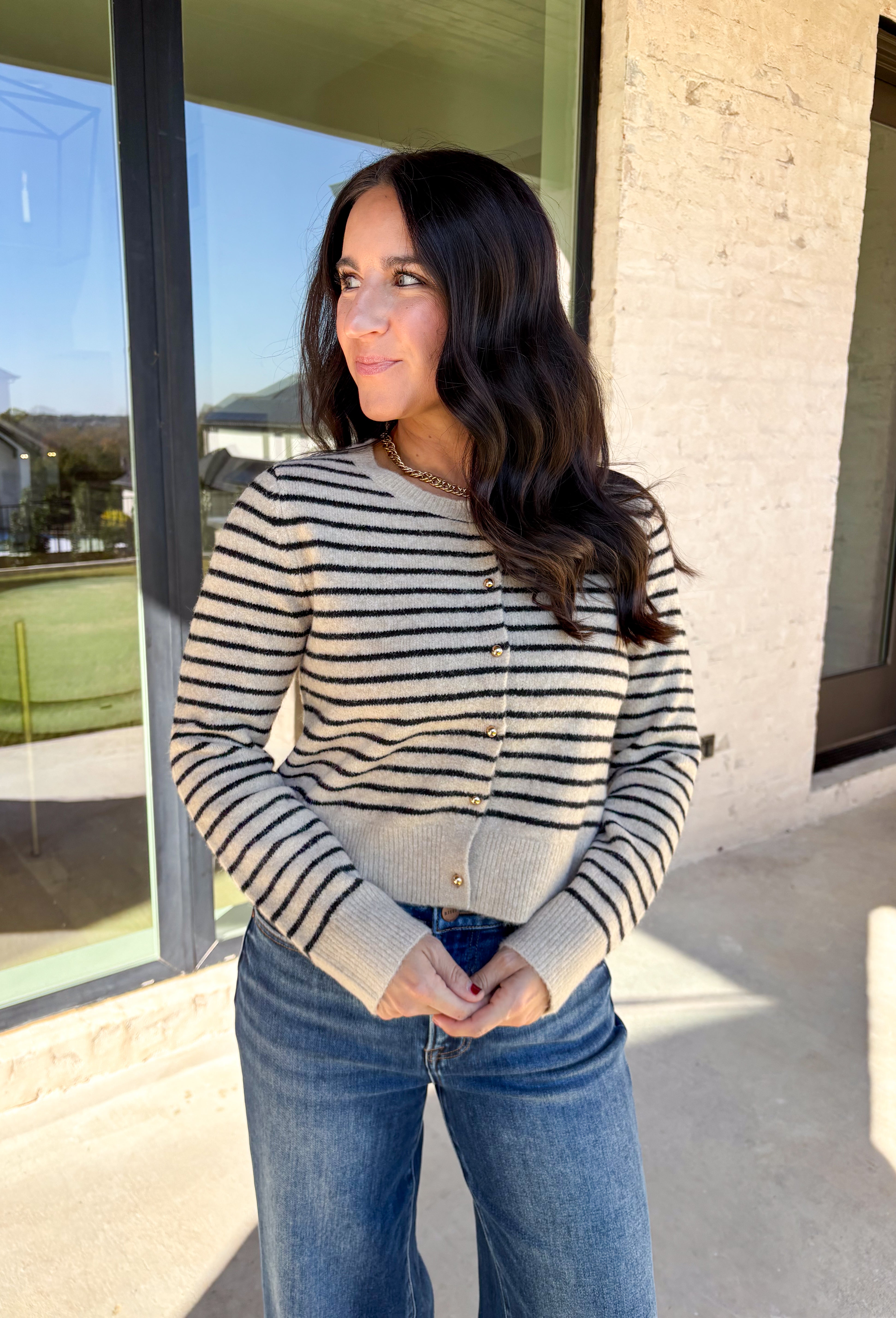 Chic, cozy, and perfect for winter layering, this taupe button-down cardigan by Paper Moon brings a modern twist to a classic stripe. Featuring black stripe detailing and gleaming gold buttons, this cropped knit adds just the right amount of polish to your cold-weather wardrobe. Soft, warm, and easy to style, it’s the ideal piece for dressing up denim or layering over your favorite winter basics.