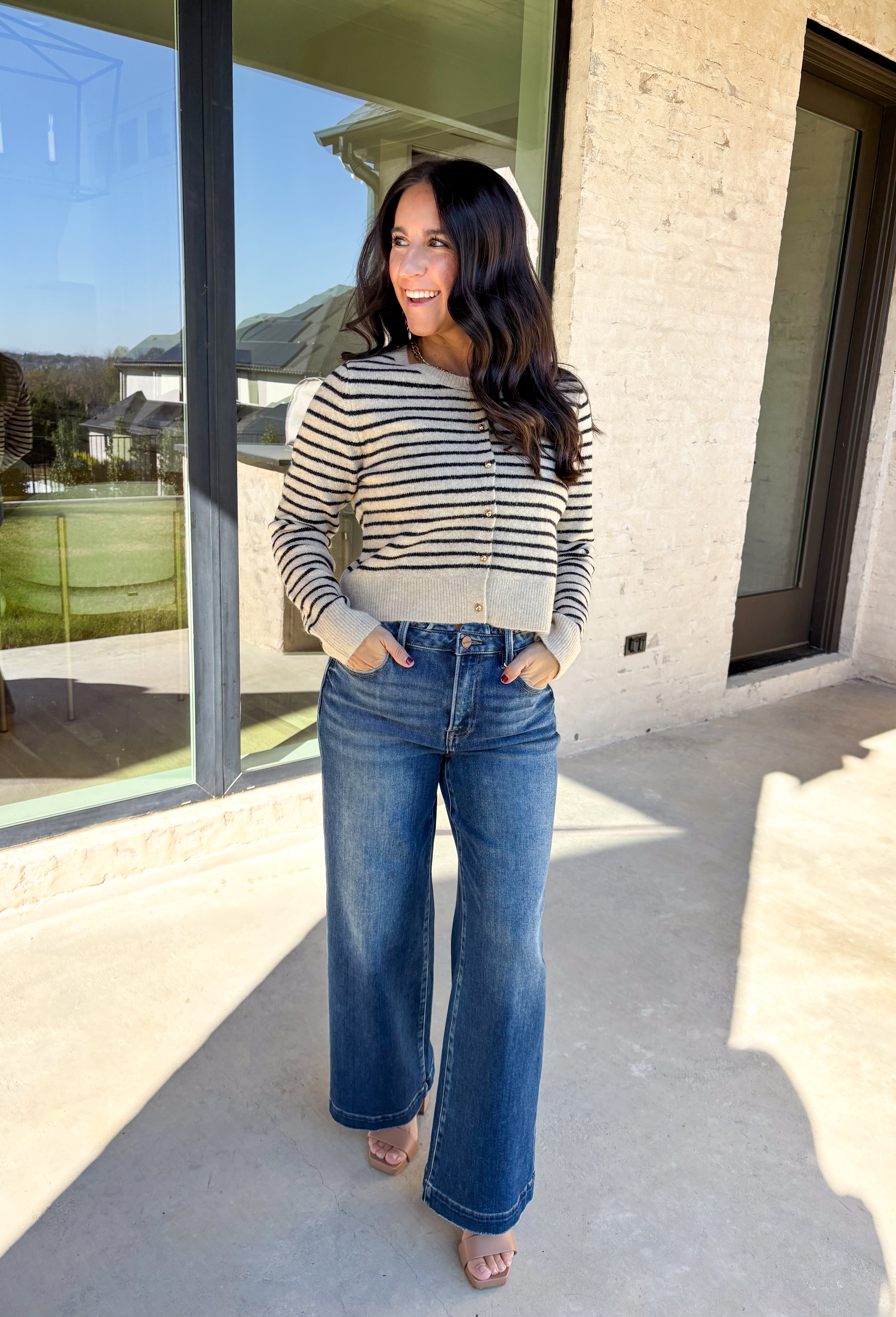 Chic, cozy, and perfect for winter layering, this taupe button-down cardigan by Paper Moon brings a modern twist to a classic stripe. Featuring black stripe detailing and gleaming gold buttons, this cropped knit adds just the right amount of polish to your cold-weather wardrobe. Soft, warm, and easy to style, it’s the ideal piece for dressing up denim or layering over your favorite winter basics.