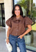 Elevate your everyday wardrobe with this effortlessly polished blouse from Entro. Designed in a rich chocolate brown hue, this timeless top features a classic button-front design with a collared neckline for a sophisticated look. Feminine puff sleeves and charming side tie details add a modern twist, creating a flattering silhouette that's easy to dress up or down. Crafted from breathable cotton, this versatile blouse is perfect for everything from office days to weekend brunches.
