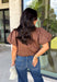 Elevate your everyday wardrobe with this effortlessly polished blouse from Entro. Designed in a rich chocolate brown hue, this timeless top features a classic button-front design with a collared neckline for a sophisticated look. Feminine puff sleeves and charming side tie details add a modern twist, creating a flattering silhouette that's easy to dress up or down. Crafted from breathable cotton, this versatile blouse is perfect for everything from office days to weekend brunches.