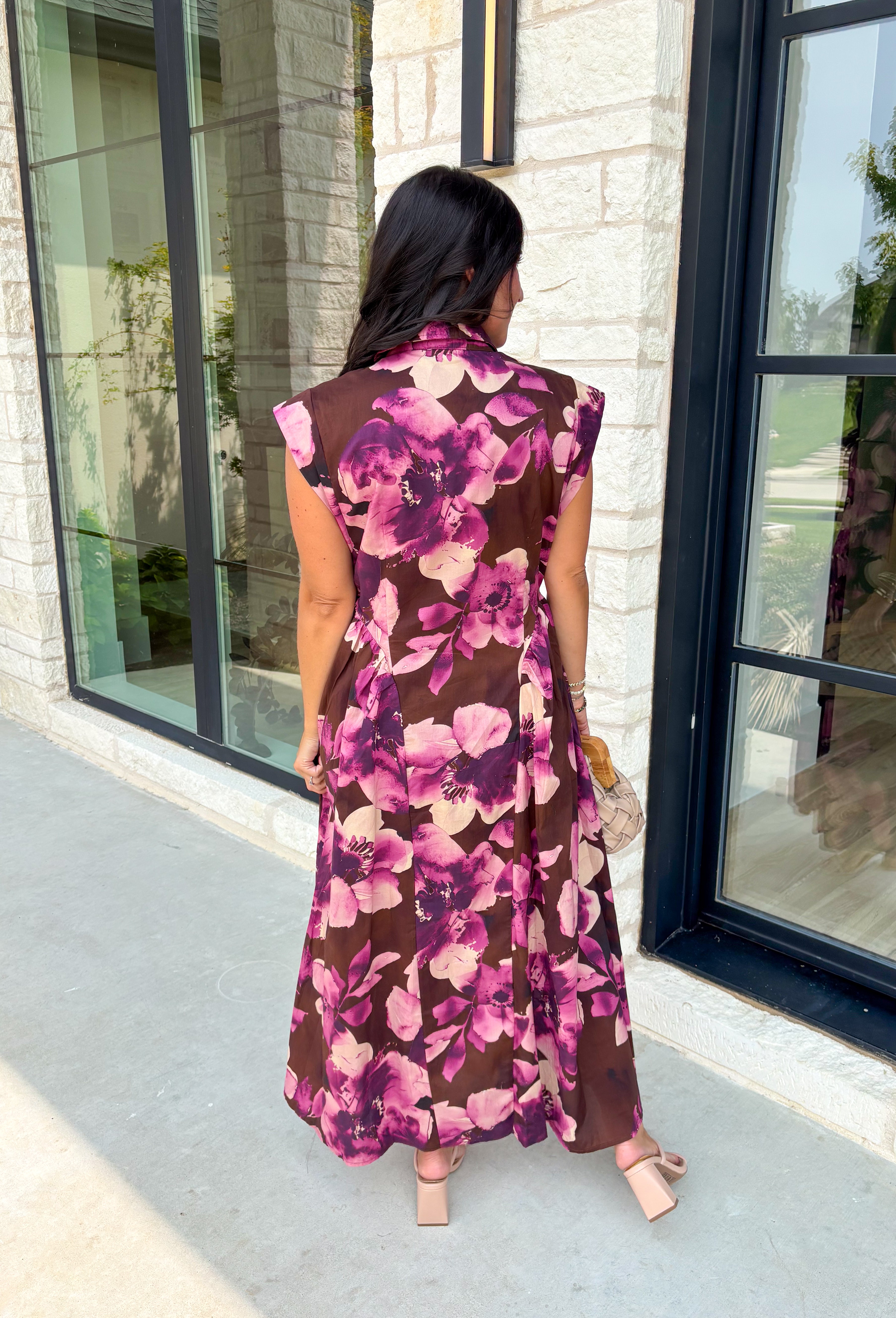 Timeless florals meet effortless comfort in this beautiful midi dress that's ready for every occasion on your fall calendar! Designed in a rich brown hue with a stunning pink and purple floral print, this cotton dress is both feminine and easy to wear. The collared v-neckline and button-front closure create a polished look, while the flowy midi silhouette and cap sleeves keep it comfortable from morning to night. 