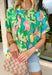 This short sleeve green top is made to brighten up your spring wardrobe with its bold, colorful floral print that truly pops. Featuring a vibrant mix of peach, pink, blue, green, brown, and white, this top feels cheerful, eye-catching, and effortlessly fun. The lightweight linen-blend fabric keeps it breathable and comfortable, while the easy silhouette makes it perfect for everyday wear. It’s the kind of top that instantly lifts your outfit—no extra styling required.