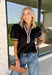 Elevate your everyday wardrobe with this effortlessly polished top from Entro. Designed in a classic black hue, this versatile blouse features beautiful tan and cream contrast binding along the flattering v-neckline for a sophisticated touch. The nonfunctional button detail at the front adds timeless charm, while the short puff sleeves with contrast cuffs create a feminine silhouette. Easy to dress up or down, this top is perfect for workdays, dinner dates, and everything in between.