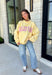 Why choose one look when you can have two? This cozy reversible pullover is full of personality with playful sayings on each side. One side features "Dilly Dally" in blue and white gingham lettering, while the fleece-lined reverse showcases "Lolly Gag" in pink and white gingham for an equally fun look. Designed with an oversized fit and a classic mock neckline, this butter yellow sweatshirt is perfect for slow mornings, coffee runs, travel days, and all your cozy fall adventures.