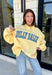 Why choose one look when you can have two? This cozy reversible pullover is full of personality with playful sayings on each side. One side features "Dilly Dally" in blue and white gingham lettering, while the fleece-lined reverse showcases "Lolly Gag" in pink and white gingham for an equally fun look. Designed with an oversized fit and a classic mock neckline, this butter yellow sweatshirt is perfect for slow mornings, coffee runs, travel days, and all your cozy fall adventures.