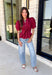 Rich seasonal color and flattering details make this merlot blouse a must-have for fall! Crafted from breathable cotton, this feminine top features a button front, soft puff sleeves, and a flattering tie waist that beautifully defines your silhouette. Pleating at the waist adds a polished touch, while the smocked back provides all-day comfort and the perfect fit. 
