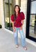 Rich seasonal color and flattering details make this merlot blouse a must-have for fall! Crafted from breathable cotton, this feminine top features a button front, soft puff sleeves, and a flattering tie waist that beautifully defines your silhouette. Pleating at the waist adds a polished touch, while the smocked back provides all-day comfort and the perfect fit. 
