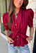 Rich seasonal color and flattering details make this merlot blouse a must-have for fall! Crafted from breathable cotton, this feminine top features a button front, soft puff sleeves, and a flattering tie waist that beautifully defines your silhouette. Pleating at the waist adds a polished touch, while the smocked back provides all-day comfort and the perfect fit. 