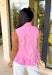 Crisp, classic, and endlessly versatile — this pink sleeveless button down top is one you’ll reach for again and again. The clean silhouette keeps it timeless, while the tie detail at the top adds a soft, feminine touch that sets it apart from your basic button downs. Finished with a subtle ruffle hem for a hint of movement and charm, this top is lightweight and breathable in 100% cotton. It’s polished enough for work and easy enough for weekend wear — the kind of staple that works all season long.