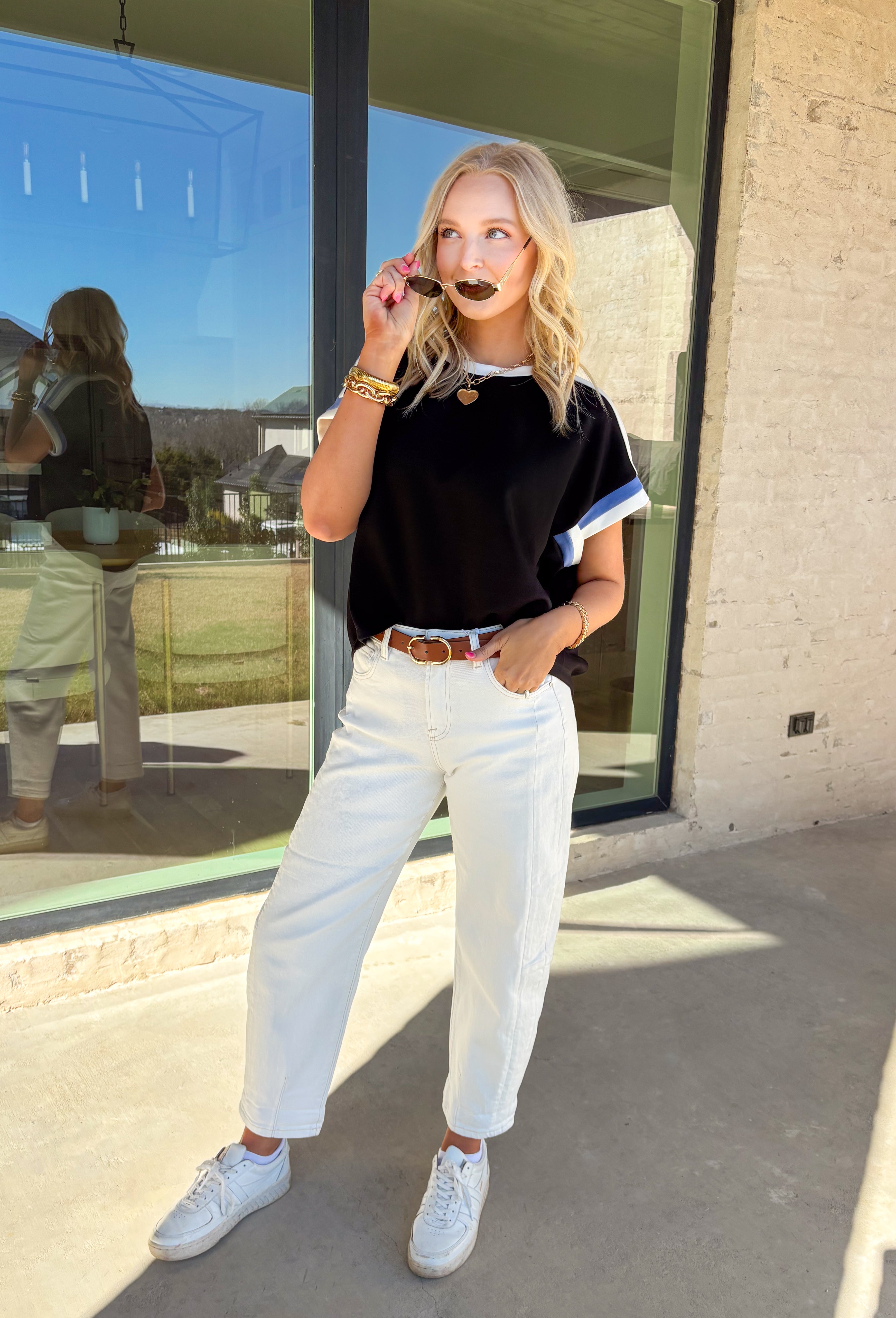 Soft, sporty, and seriously comfortable, this black short sleeve top by Entro is the kind of everyday staple you’ll reach for again and again. Made from a buttery soft fabric, it features crisp white and blue trim along the neckline and sleeves for a fresh pop of contrast. Easy to dress up or down, this top is perfect for spring days when you want to look put together without sacrificing comfort.