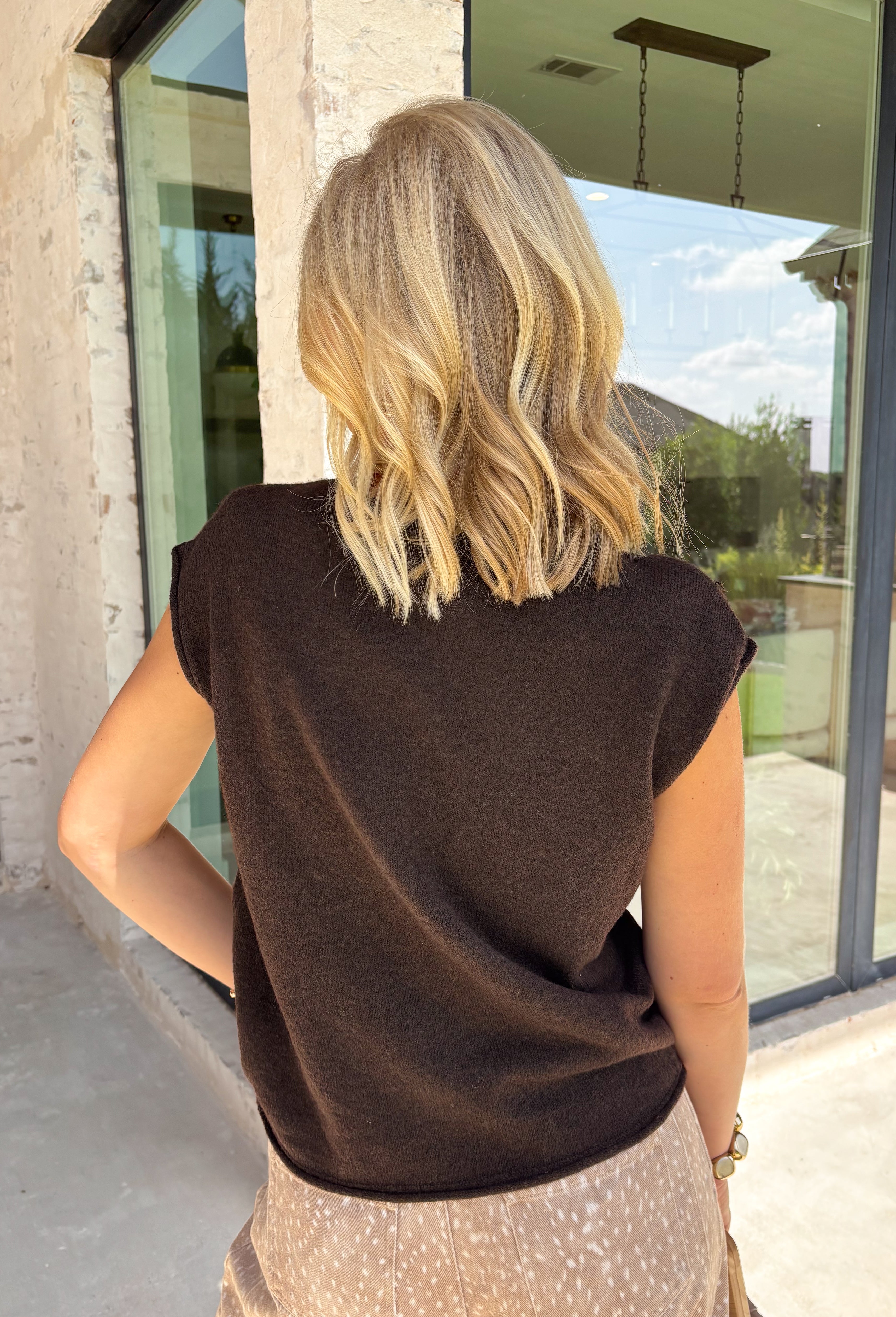 The perfect layering piece for fall has arrived! This chocolate brown sleeveless button-down cardigan is a timeless staple you'll reach for again and again. Crafted from a soft, lightweight knit, it's cozy without feeling bulky, making it perfect for layering over dresses, fitted tees, or long sleeve tops as the weather cools. Whether you wear it buttoned as a sweater vest or open for a relaxed layered look, this versatile knit is an effortless addition to your autumn wardrobe.