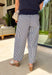Easy, breezy, and effortlessly put-together! These navy and white stripe barrel pants bring a fresh, coastal-inspired feel to your everyday style. The relaxed barrel silhouette gives them a modern edge, while the classic stripe print keeps them timeless and easy to pair with anything. Subtle metal grommet details add just the right touch of interest, giving these pants a slightly elevated feel. Designed with an elastic waistband, they’re as comfortable as they are stylish—perfect for all-day wear.