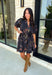 Embrace the beauty of the season in this effortlessly feminine floral dress that's made for all your favorite fall occasions. Designed with a classic black backdrop and adorned with a rich floral print in gorgeous autumn-inspired hues, this dress is the perfect combination of timeless elegance and everyday comfort. The ruffled v-neckline and puff sleeves add a romantic touch, while the self-tie waist creates a flattering silhouette you'll love. 