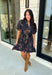 Embrace the beauty of the season in this effortlessly feminine floral dress that's made for all your favorite fall occasions. Designed with a classic black backdrop and adorned with a rich floral print in gorgeous autumn-inspired hues, this dress is the perfect combination of timeless elegance and everyday comfort. The ruffled v-neckline and puff sleeves add a romantic touch, while the self-tie waist creates a flattering silhouette you'll love. 