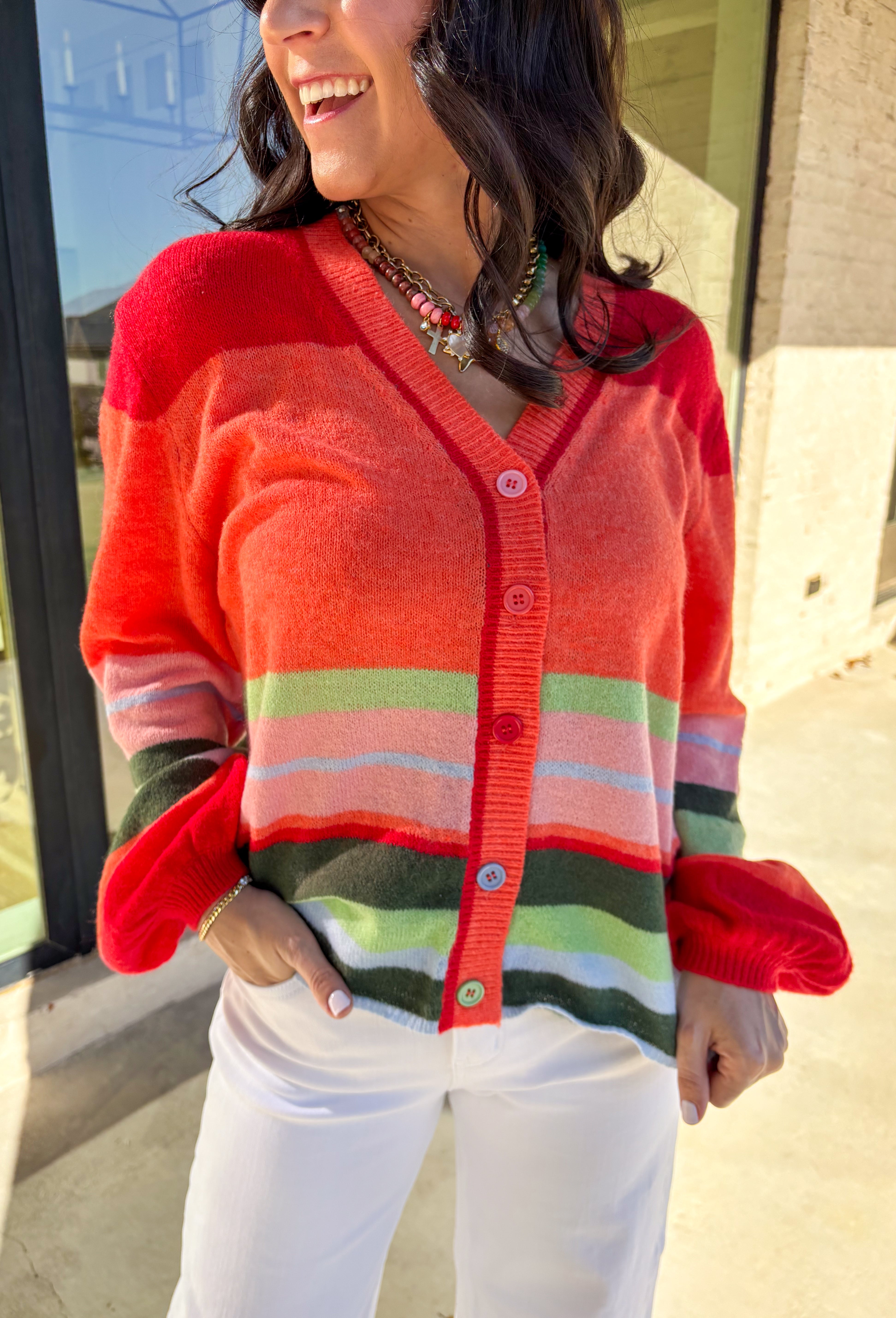 Bright, cozy, and perfect for spring layering, this coral button-down cardigan by Fate adds a happy pop of color to any outfit. Featuring a playful mix of red, pink, green, and blue stripes, this lightweight knit feels fun yet easy to wear. Soft and comfortable with just the right amount of warmth, it’s ideal for breezy mornings, cool evenings, or tossing on over your favorite spring basics.
