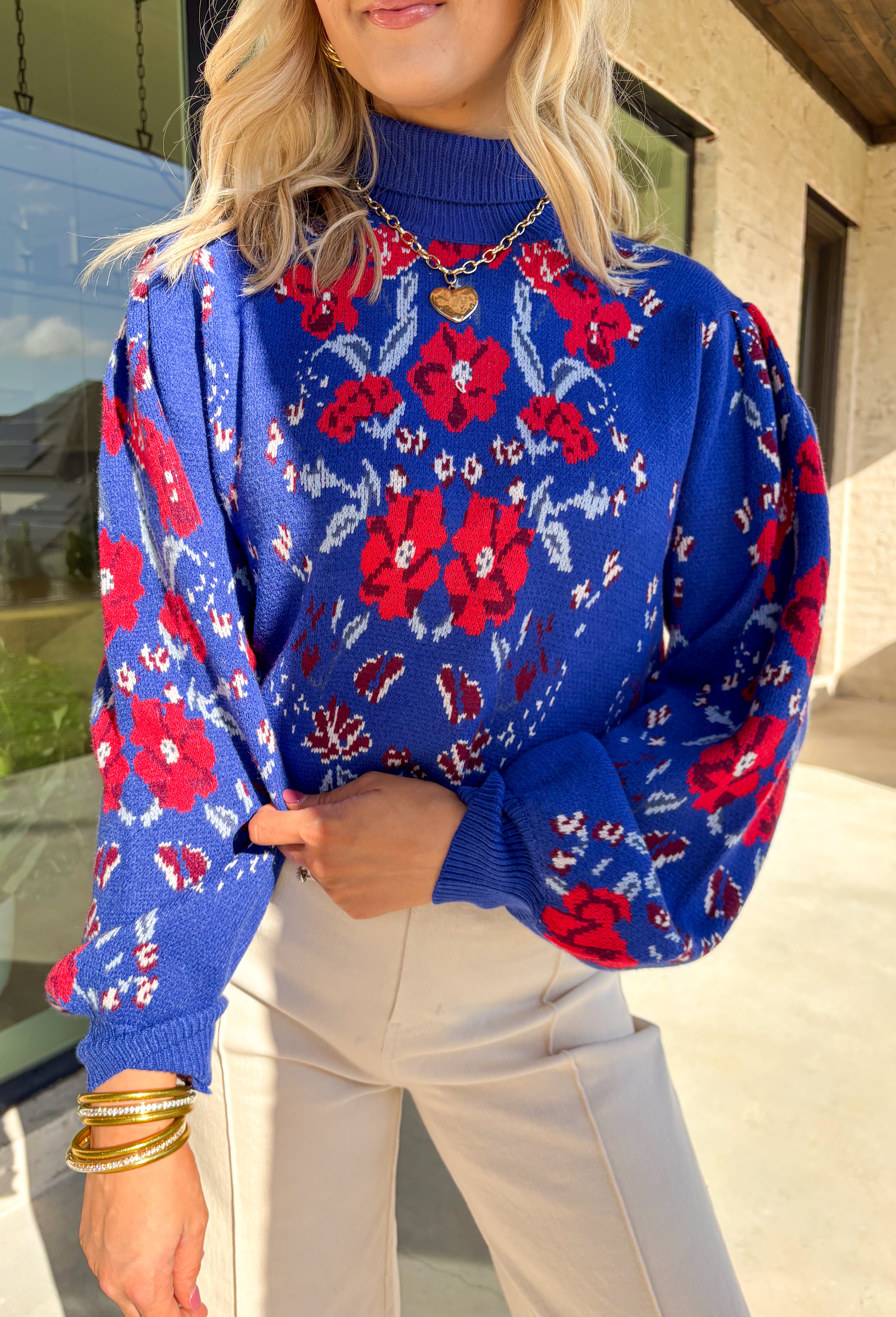 Brighten chilly days with this stunning royal blue turtleneck sweater by Voy. Adorned with a bold floral print in shades of red, blue, white, and burgundy, this cozy knit brings a cheerful pop of color to your winter wardrobe. The soft fabric blend offers both warmth and comfort, making it perfect for layering or wearing on its own for a statement cold-weather look.