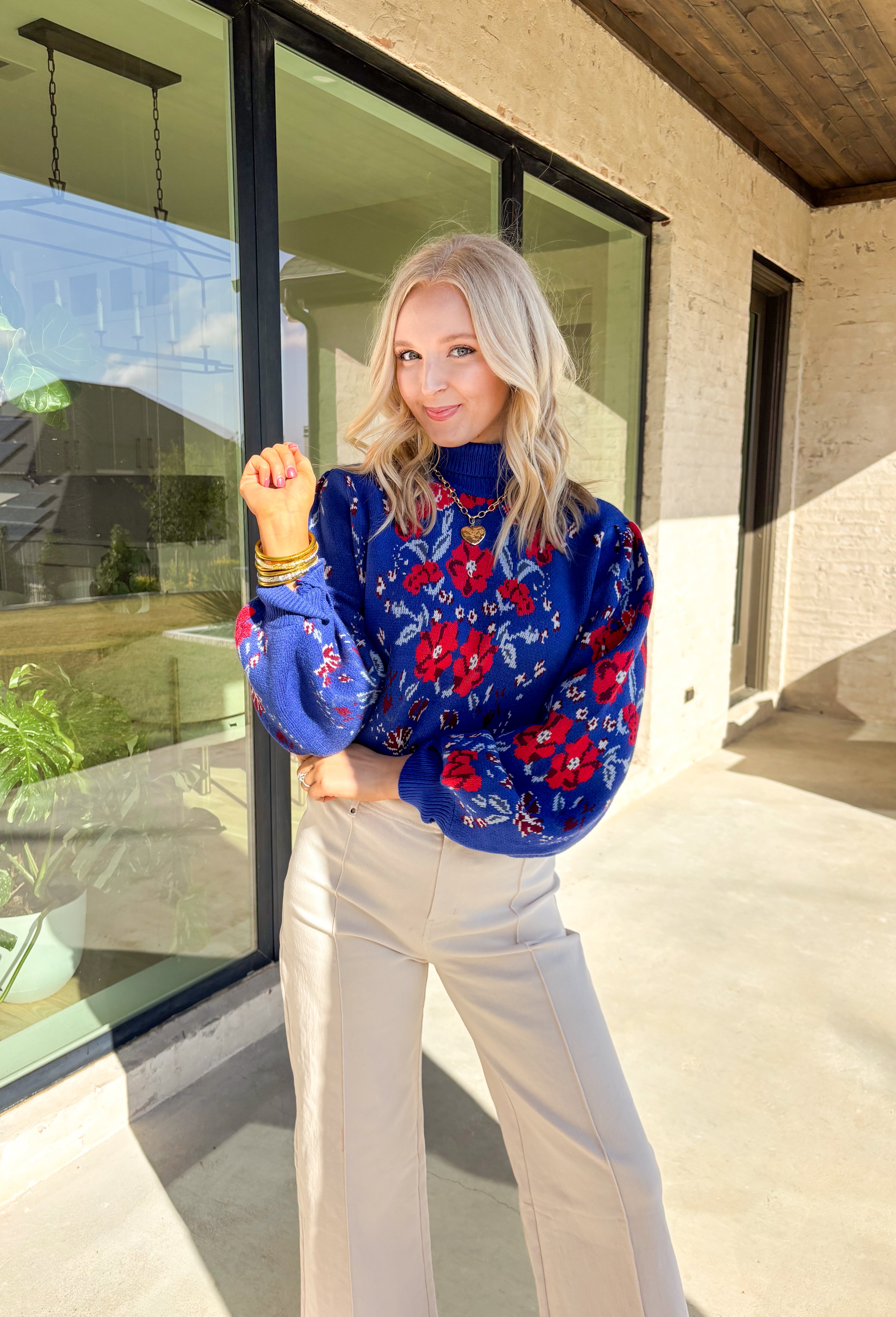 Brighten chilly days with this stunning royal blue turtleneck sweater by Voy. Adorned with a bold floral print in shades of red, blue, white, and burgundy, this cozy knit brings a cheerful pop of color to your winter wardrobe. The soft fabric blend offers both warmth and comfort, making it perfect for layering or wearing on its own for a statement cold-weather look.