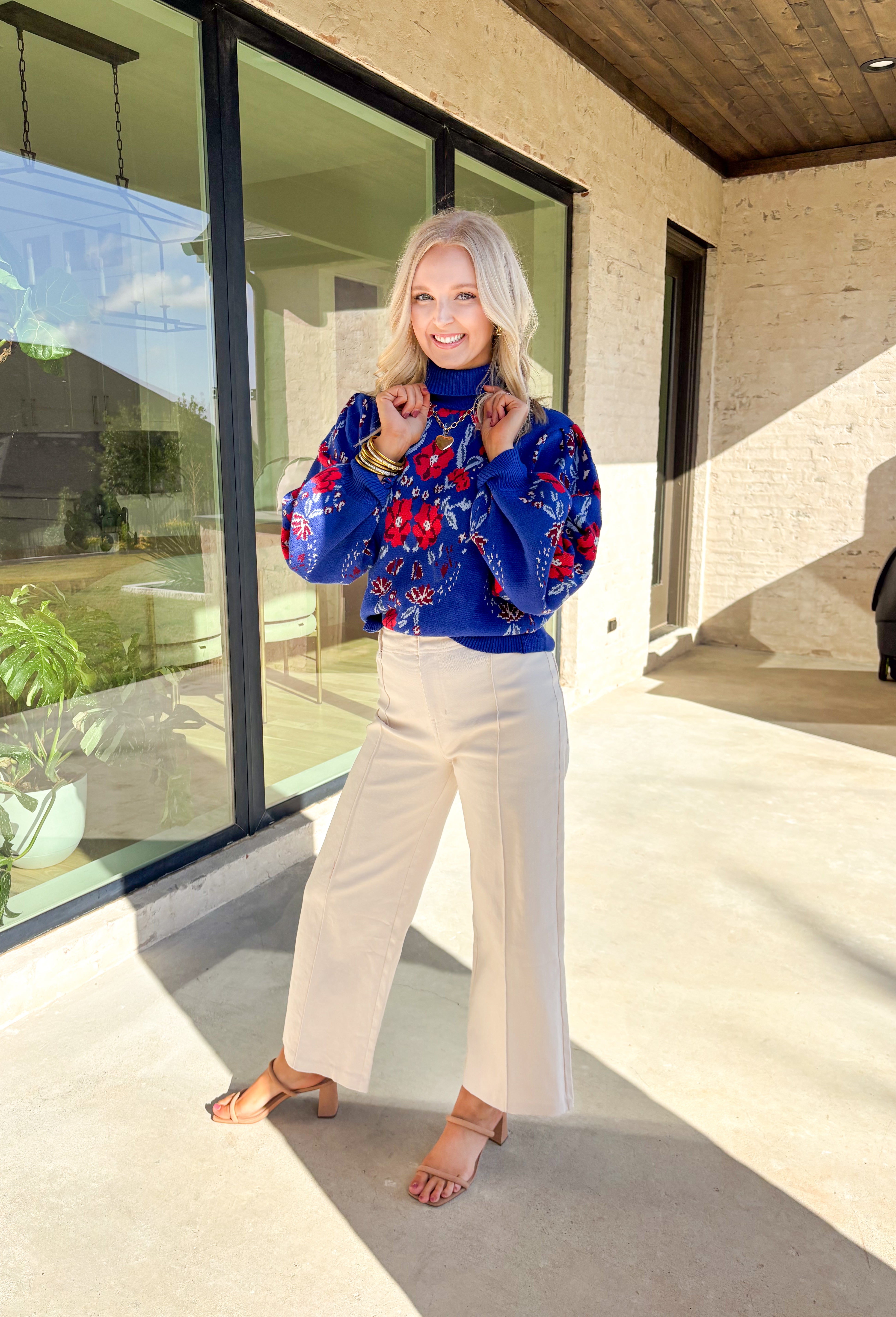 Brighten chilly days with this stunning royal blue turtleneck sweater by Voy. Adorned with a bold floral print in shades of red, blue, white, and burgundy, this cozy knit brings a cheerful pop of color to your winter wardrobe. The soft fabric blend offers both warmth and comfort, making it perfect for layering or wearing on its own for a statement cold-weather look.