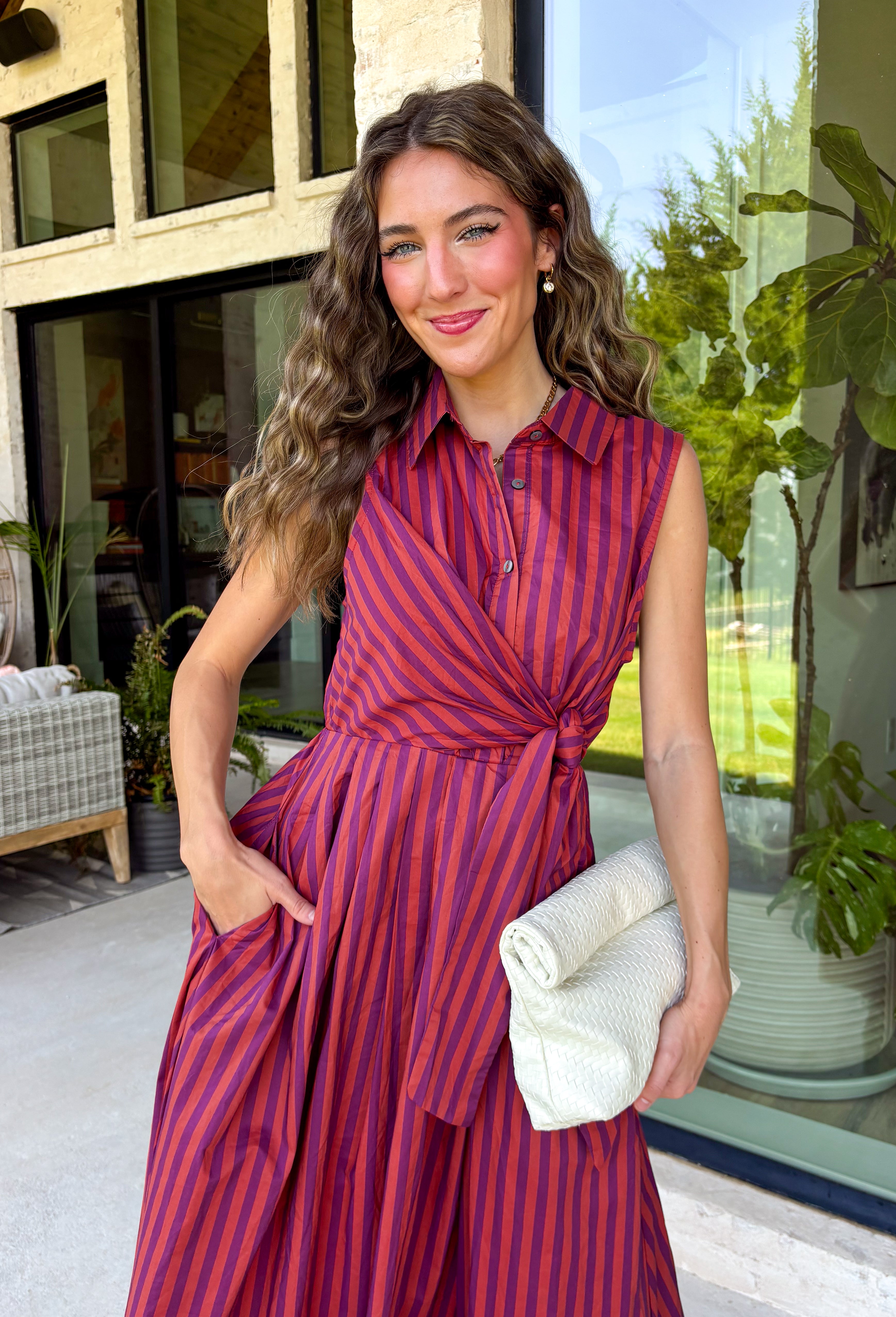 Bring effortless charm to your fall wardrobe with this beautifully detailed midi dress from Entro. Featuring rich plum and rust stripes, this timeless dress combines classic style with feminine touches you'll love. The collared neckline and button-front design create a polished silhouette, while the self-tie detail at the front adds a flattering, playful finish. 