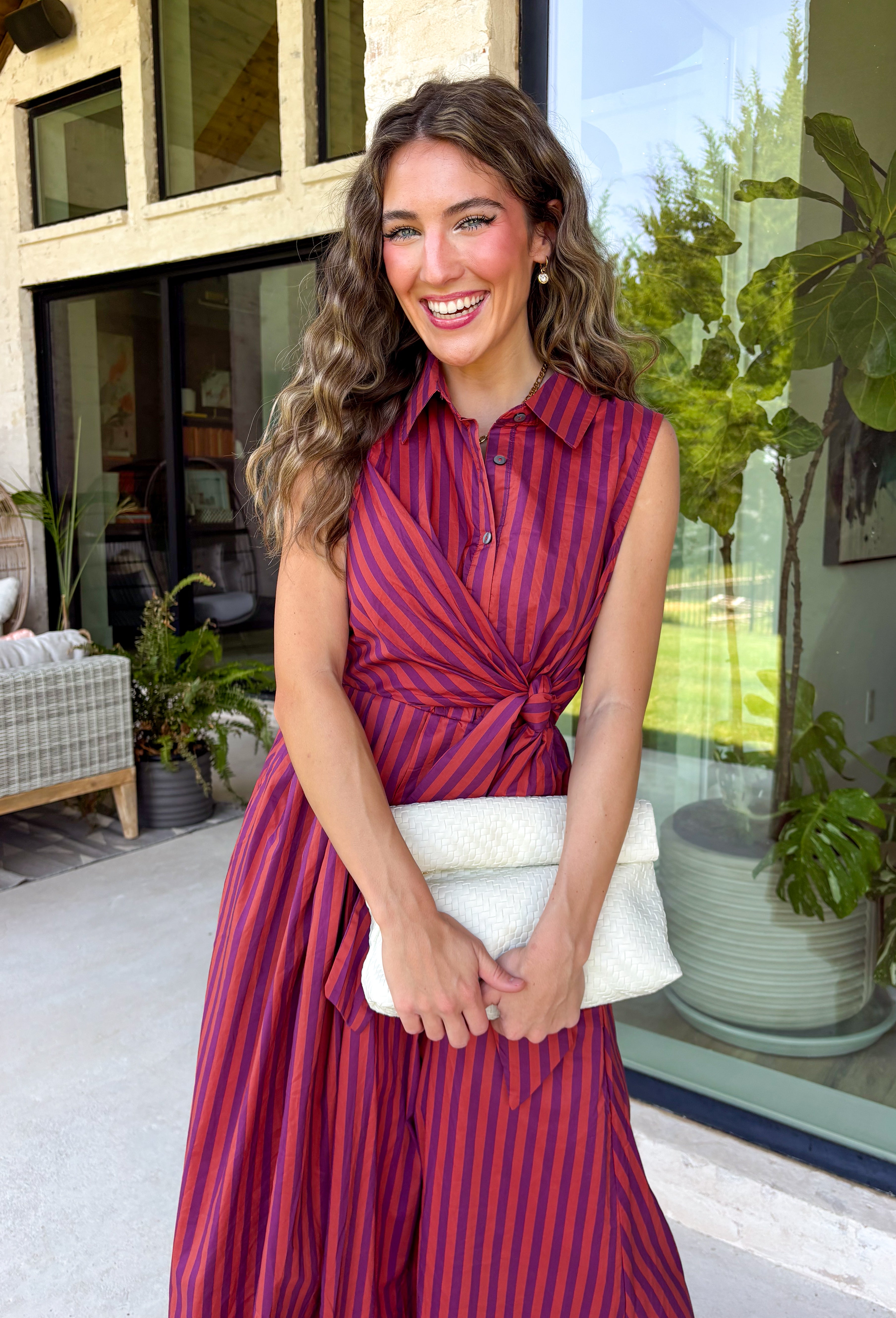 Bring effortless charm to your fall wardrobe with this beautifully detailed midi dress from Entro. Featuring rich plum and rust stripes, this timeless dress combines classic style with feminine touches you'll love. The collared neckline and button-front design create a polished silhouette, while the self-tie detail at the front adds a flattering, playful finish. 