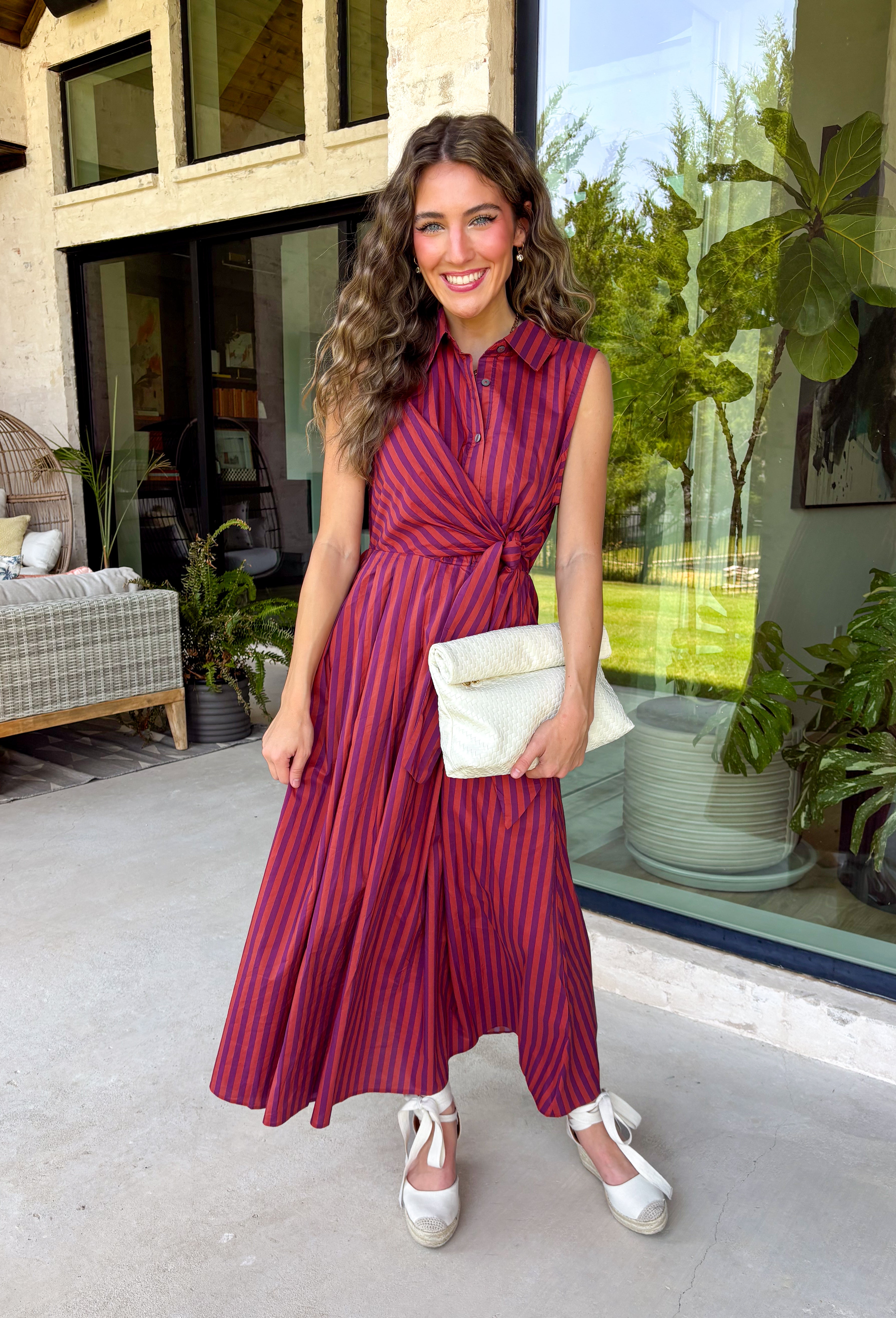 Bring effortless charm to your fall wardrobe with this beautifully detailed midi dress from Entro. Featuring rich plum and rust stripes, this timeless dress combines classic style with feminine touches you'll love. The collared neckline and button-front design create a polished silhouette, while the self-tie detail at the front adds a flattering, playful finish. 