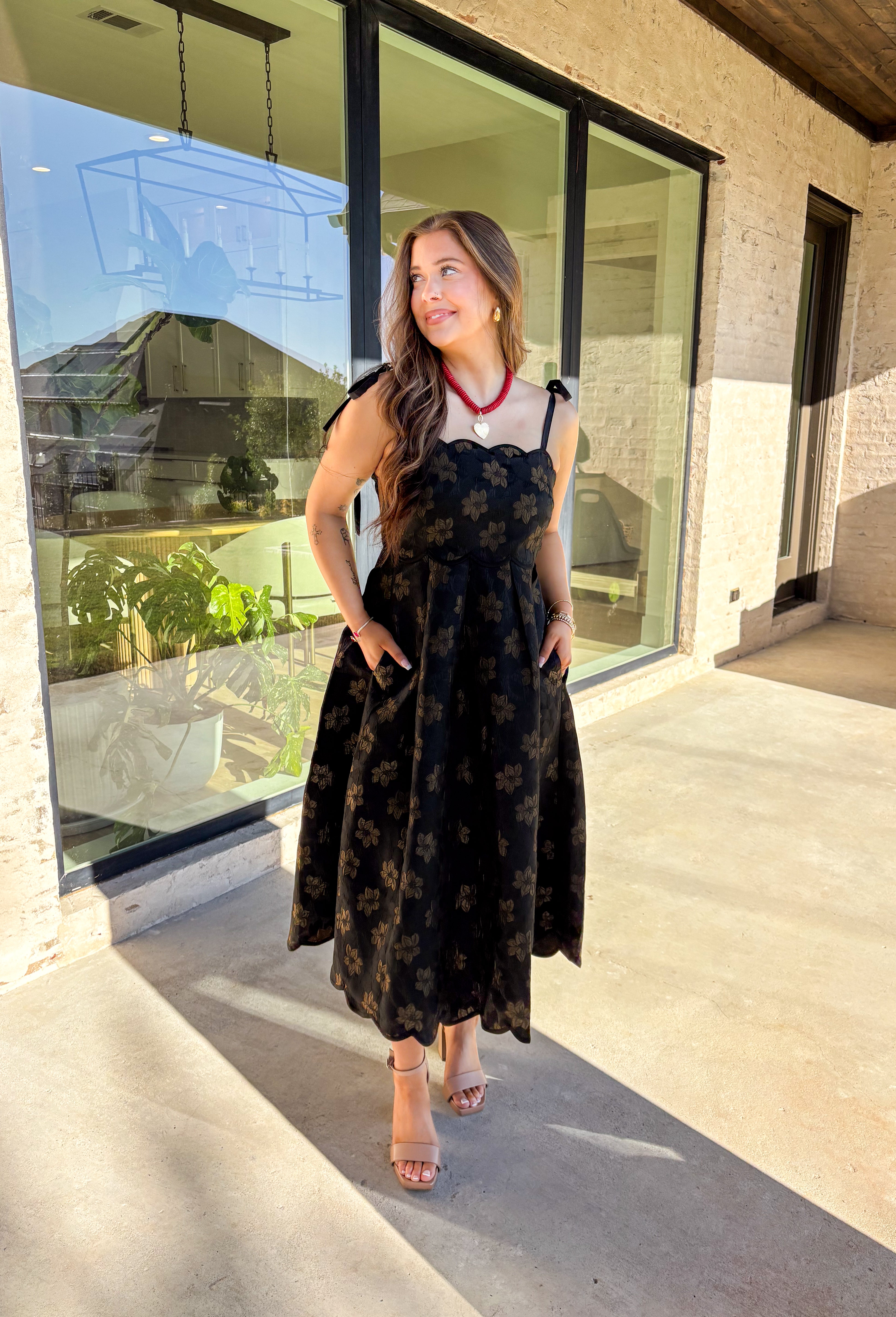 When the invite calls for dressy but you still want to feel comfortable, this is the dress. In classic black with a subtle gold floral texture that feels lace-like, it’s a showstopper without being over the top. The scalloped neckline and hem add a romantic finish, while the self-tie straps let you adjust for the perfect fit. Whether you’re attending a wedding, holiday party, or a candlelit dinner, this midi is a timeless choice you’ll wear for seasons to come.