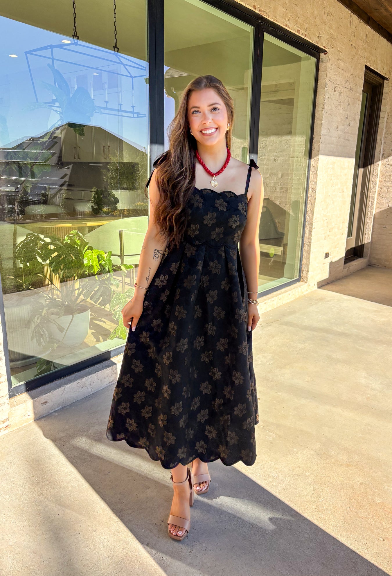 When the invite calls for dressy but you still want to feel comfortable, this is the dress. In classic black with a subtle gold floral texture that feels lace-like, it’s a showstopper without being over the top. The scalloped neckline and hem add a romantic finish, while the self-tie straps let you adjust for the perfect fit. Whether you’re attending a wedding, holiday party, or a candlelit dinner, this midi is a timeless choice you’ll wear for seasons to come.