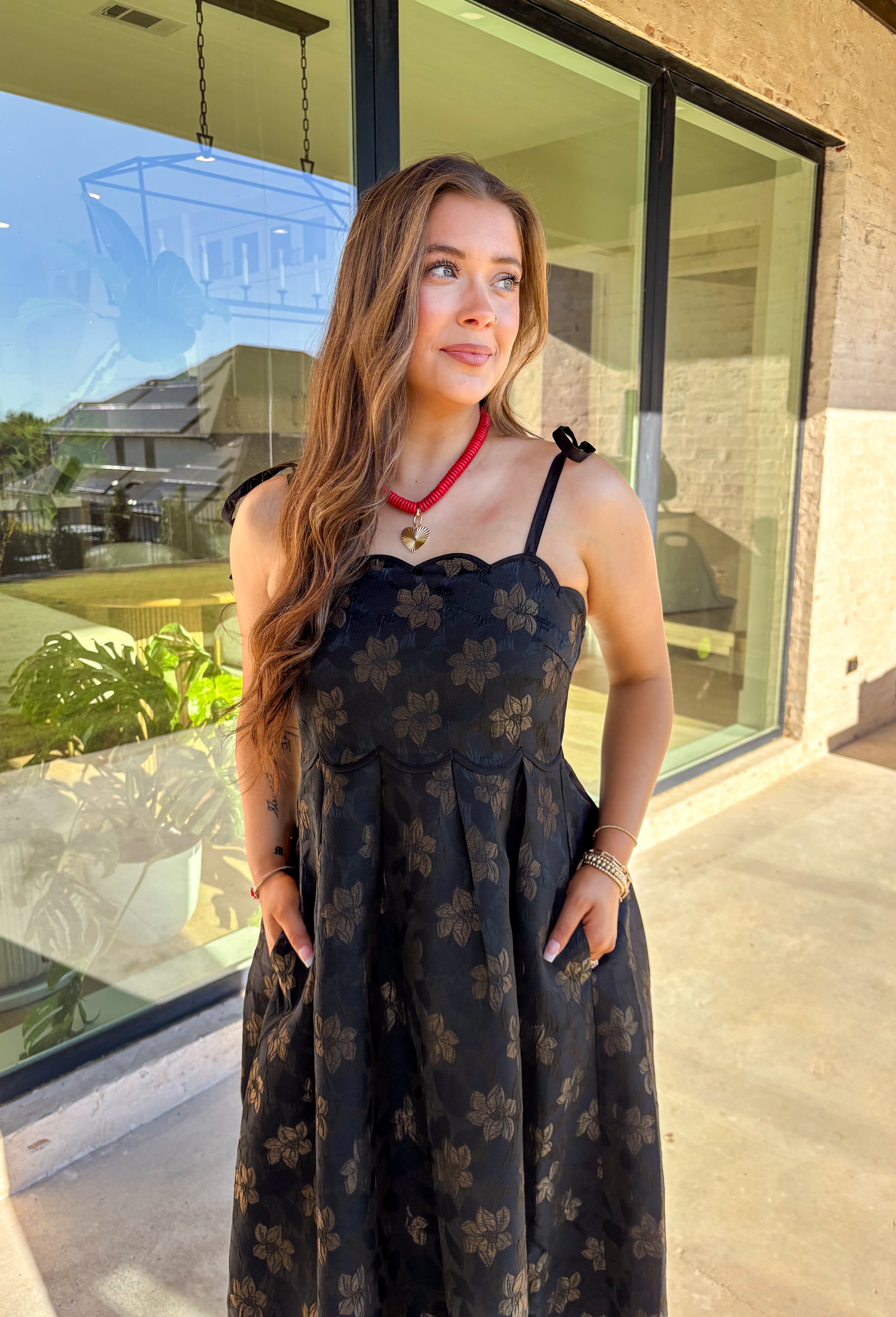 When the invite calls for dressy but you still want to feel comfortable, this is the dress. In classic black with a subtle gold floral texture that feels lace-like, it’s a showstopper without being over the top. The scalloped neckline and hem add a romantic finish, while the self-tie straps let you adjust for the perfect fit. Whether you’re attending a wedding, holiday party, or a candlelit dinner, this midi is a timeless choice you’ll wear for seasons to come.