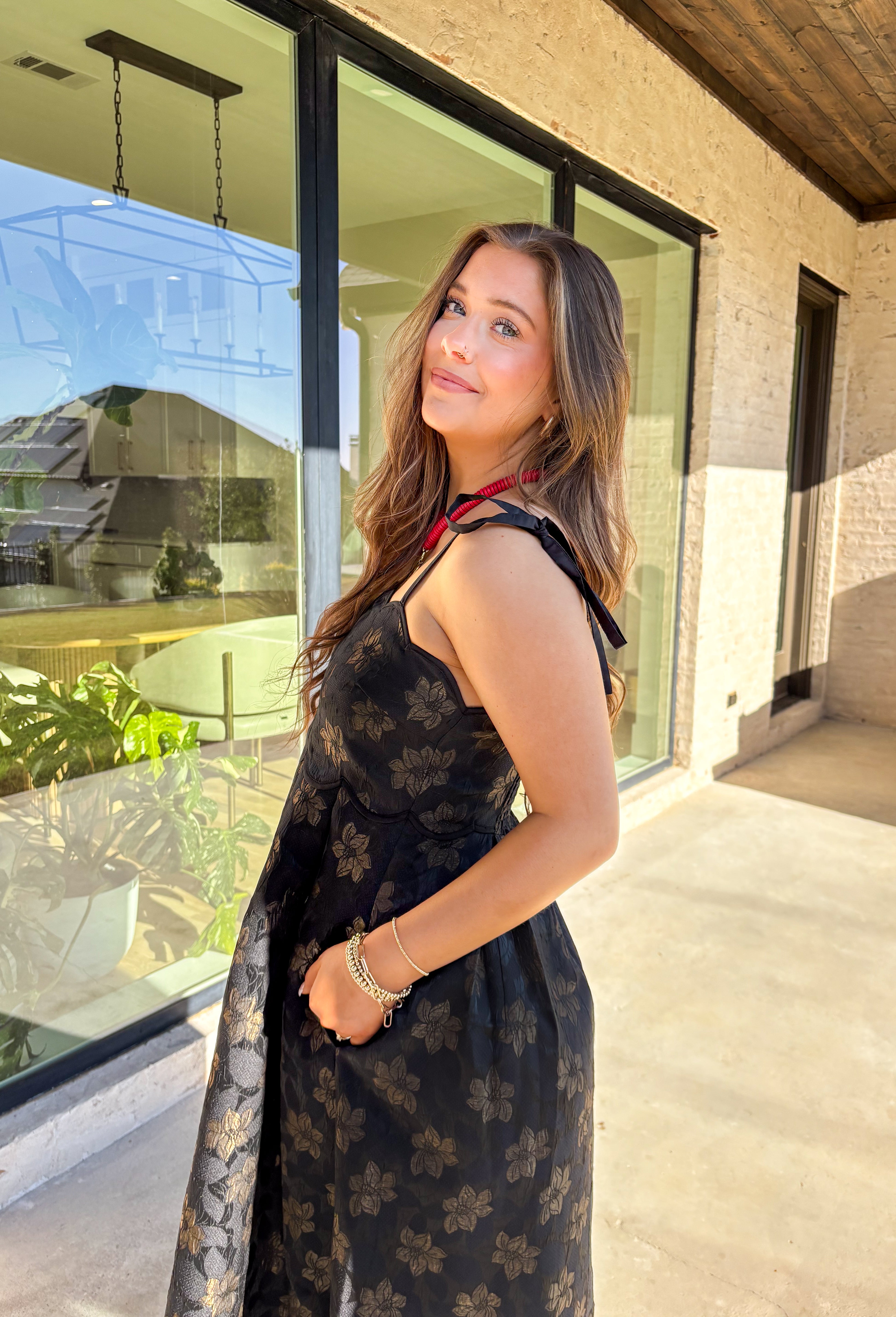 When the invite calls for dressy but you still want to feel comfortable, this is the dress. In classic black with a subtle gold floral texture that feels lace-like, it’s a showstopper without being over the top. The scalloped neckline and hem add a romantic finish, while the self-tie straps let you adjust for the perfect fit. Whether you’re attending a wedding, holiday party, or a candlelit dinner, this midi is a timeless choice you’ll wear for seasons to come.