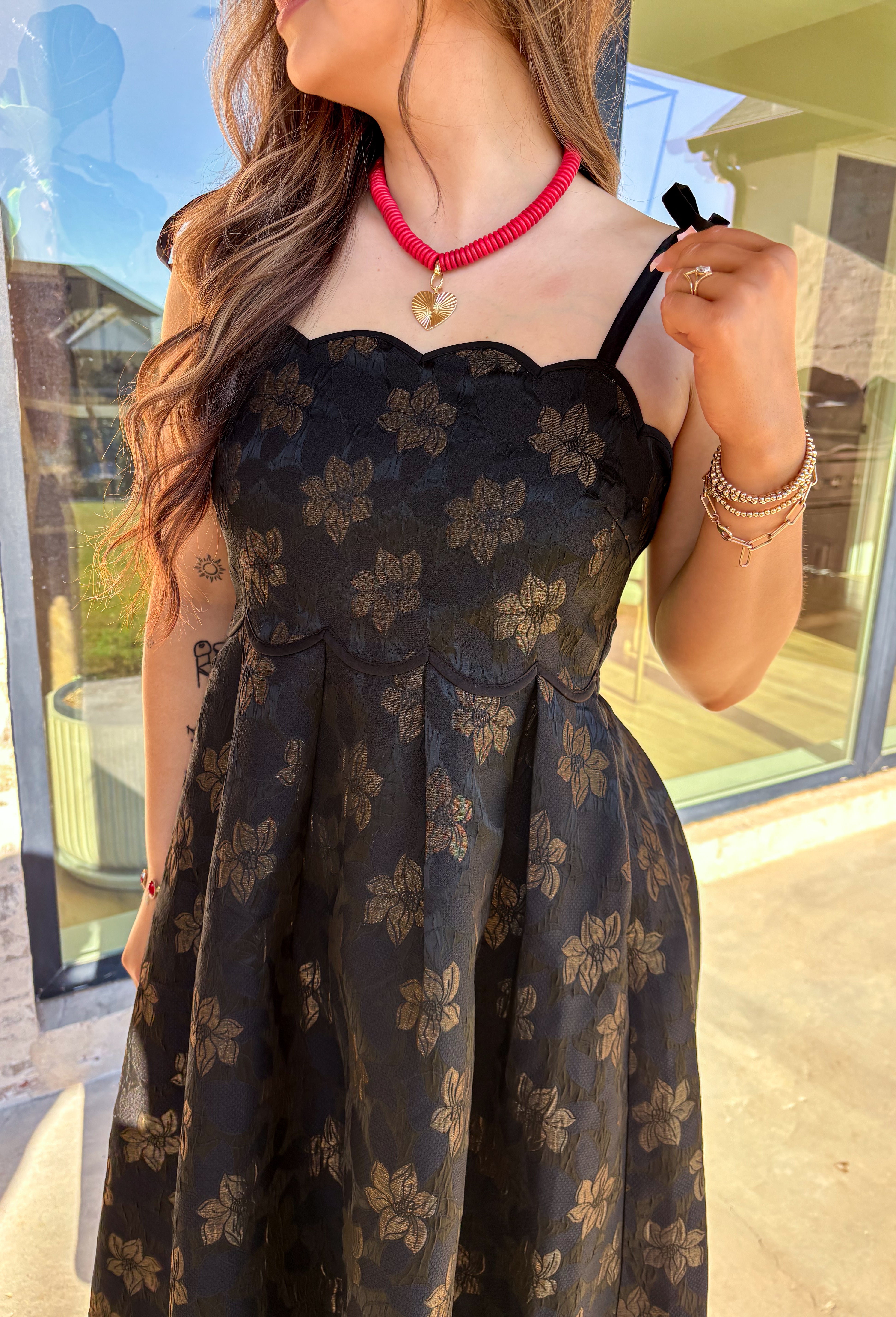 When the invite calls for dressy but you still want to feel comfortable, this is the dress. In classic black with a subtle gold floral texture that feels lace-like, it’s a showstopper without being over the top. The scalloped neckline and hem add a romantic finish, while the self-tie straps let you adjust for the perfect fit. Whether you’re attending a wedding, holiday party, or a candlelit dinner, this midi is a timeless choice you’ll wear for seasons to come.