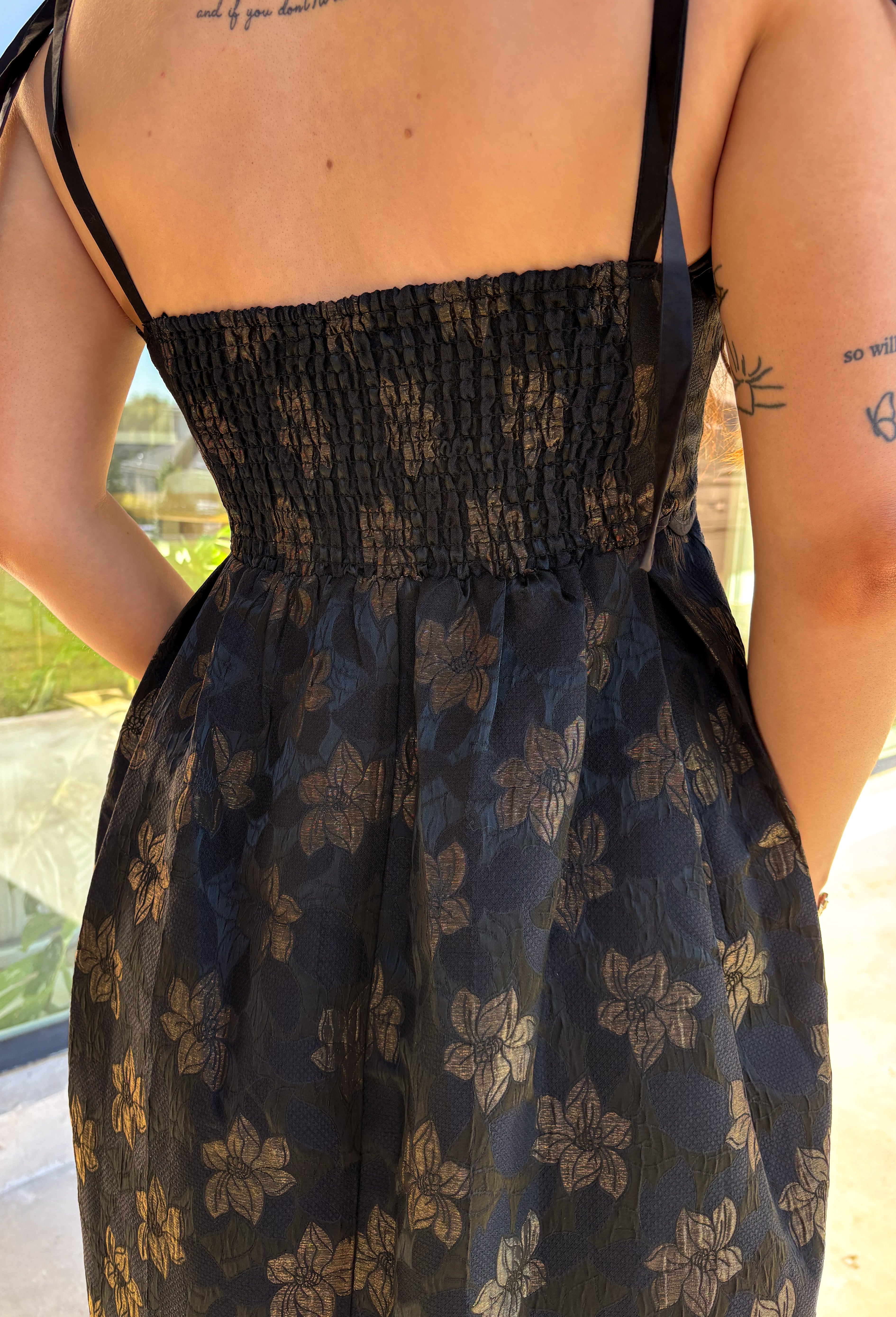 When the invite calls for dressy but you still want to feel comfortable, this is the dress. In classic black with a subtle gold floral texture that feels lace-like, it’s a showstopper without being over the top. The scalloped neckline and hem add a romantic finish, while the self-tie straps let you adjust for the perfect fit. Whether you’re attending a wedding, holiday party, or a candlelit dinner, this midi is a timeless choice you’ll wear for seasons to come.