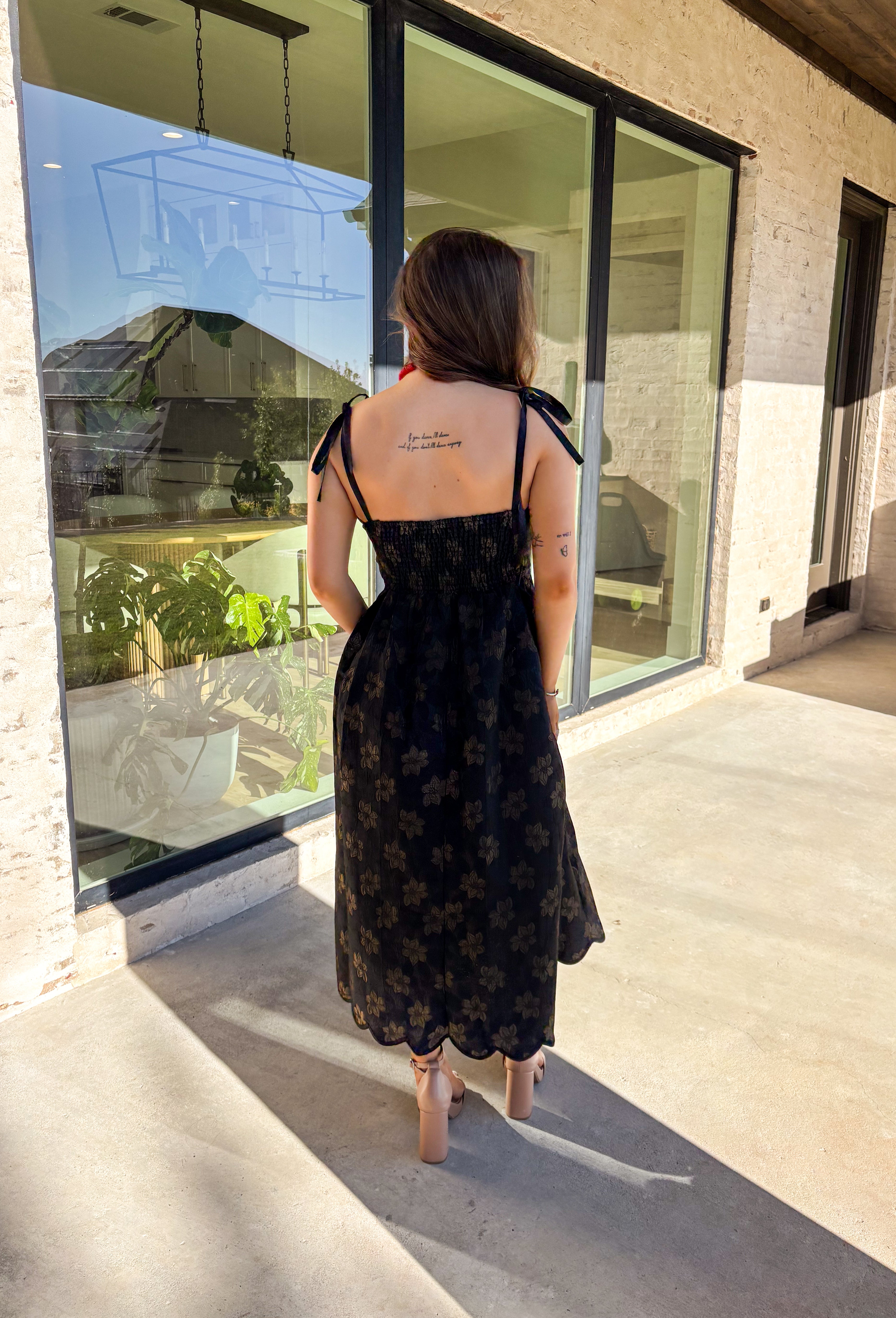 When the invite calls for dressy but you still want to feel comfortable, this is the dress. In classic black with a subtle gold floral texture that feels lace-like, it’s a showstopper without being over the top. The scalloped neckline and hem add a romantic finish, while the self-tie straps let you adjust for the perfect fit. Whether you’re attending a wedding, holiday party, or a candlelit dinner, this midi is a timeless choice you’ll wear for seasons to come.