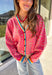 Get ready to turn heads and break up those neutral fall layers with a pop of wild color. This button-down leopard cardigan takes cozy to the next level with its bold pink print on a soft tan background—perfect for making your everyday denim look feel instantly exciting. The colorful trim adds even more personality, making this the ultimate statement layering piece.