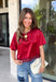 A rich red satin gives this short sleeve top from Sunday Edition the perfect festive feel for the holiday season. The smooth fabric adds a pretty touch of shine, while the lace hem brings in a soft detail that dresses up the simple silhouette. A keyhole opening at the back adds a finishing touch without taking away from the easy-to-style design. It’s a fun option for everything from Christmas parties and holiday dinners to festive date nights and seasonal get-togethers. 