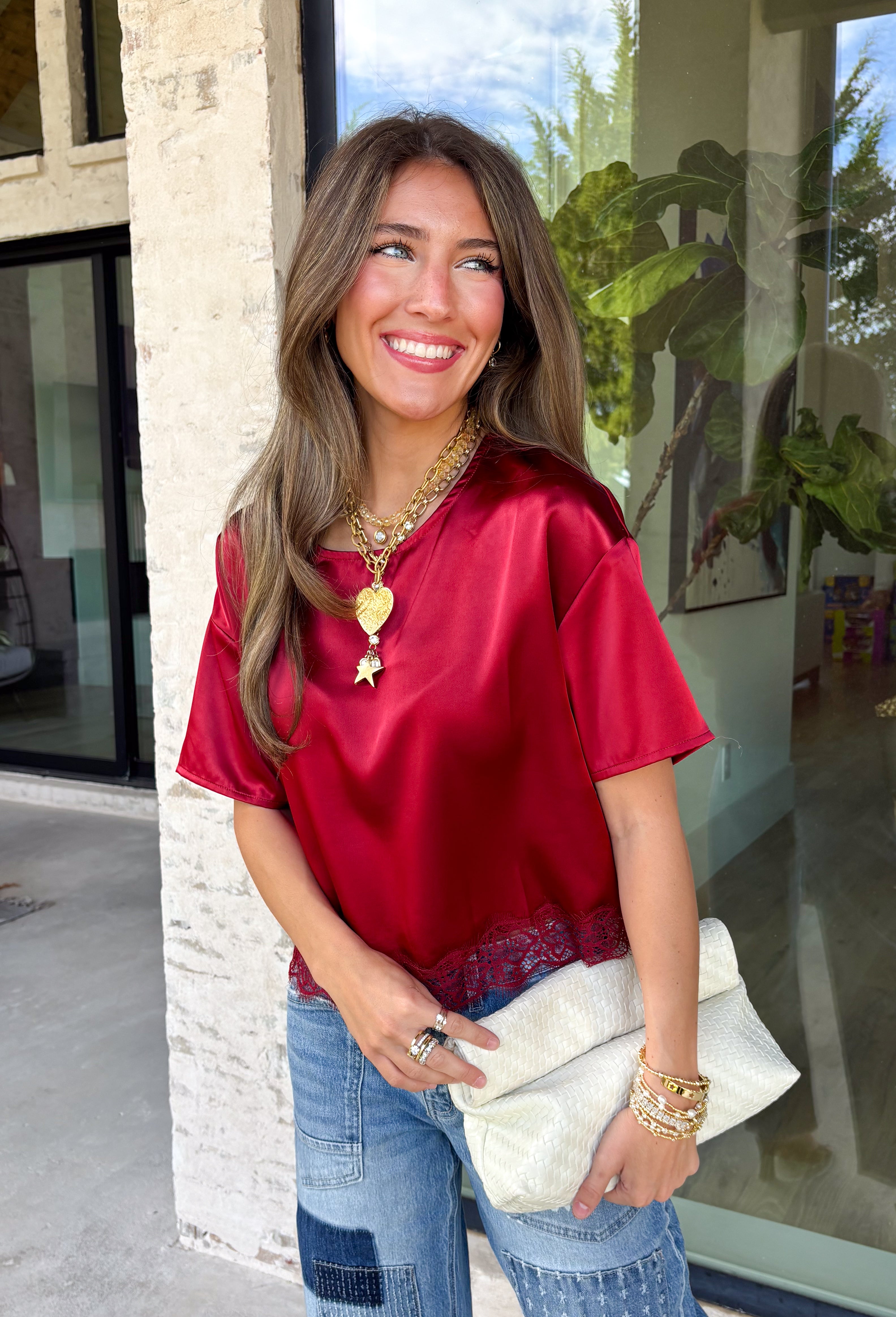 A rich red satin gives this short sleeve top from Sunday Edition the perfect festive feel for the holiday season. The smooth fabric adds a pretty touch of shine, while the lace hem brings in a soft detail that dresses up the simple silhouette. A keyhole opening at the back adds a finishing touch without taking away from the easy-to-style design. It’s a fun option for everything from Christmas parties and holiday dinners to festive date nights and seasonal get-togethers. 
