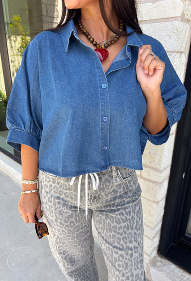 A classic denim top is a staple you'll reach for season after season! Crafted from soft medium wash denim, this effortless button-down blouse is designed with relaxed dolman sleeves and a subtle high-low hem for an easy, flattering fit. The collared neckline adds a timeless touch, making it simple to dress up or keep casual. Whether you're layering it under a blazer or wearing it on its own with your favorite fall denim, this versatile piece belongs in every autumn wardrobe.