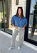 A classic denim top is a staple you'll reach for season after season! Crafted from soft medium wash denim, this effortless button-down blouse is designed with relaxed dolman sleeves and a subtle high-low hem for an easy, flattering fit. The collared neckline adds a timeless touch, making it simple to dress up or keep casual. Whether you're layering it under a blazer or wearing it on its own with your favorite fall denim, this versatile piece belongs in every autumn wardrobe.