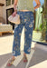 Fresh, fun, and effortlessly wearable, these medium wash wide leg jeans by Entro are a perfect way to bring florals into your spring denim lineup. Featuring a muted floral print throughout, they add subtle interest while still feeling easy to style. The exposed seam down the front gives a flattering, elongating look, and the wide leg silhouette keeps them relaxed and on-trend. These are the kind of jeans that make even a simple tee feel styled.