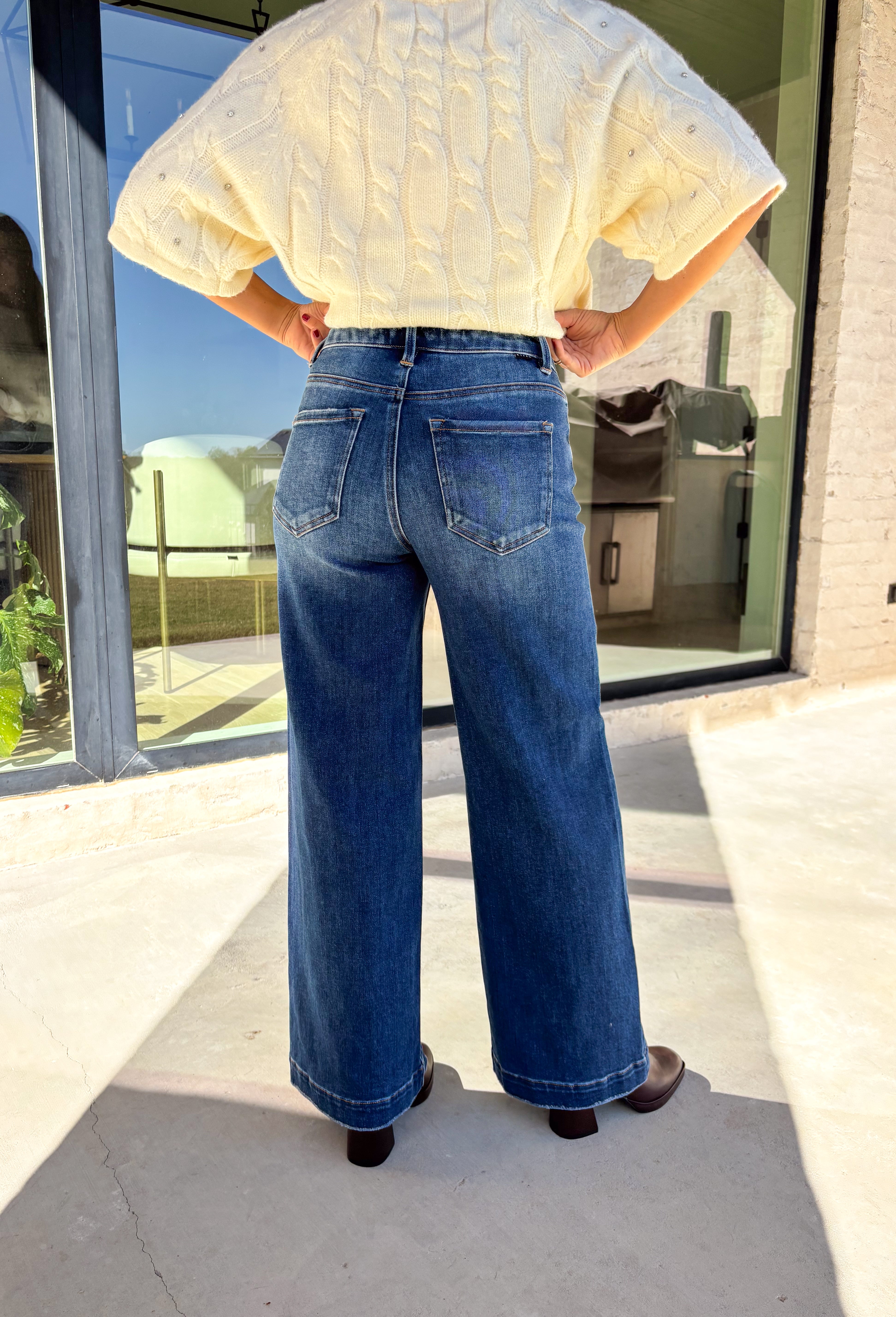 A timeless denim favorite for the season, these dark wash wide leg jeans by Risen are a must-have in every winter wardrobe. Designed with a flattering high-rise fit and a clean, classic finish, they’re easy to dress up or down. The soft stretch denim offers all-day comfort while maintaining their structured look—perfect for pairing with cozy sweaters or sleek boots.