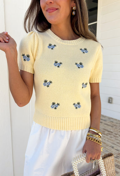 Soft, cheerful, and made for sunny days! This butter yellow ribbed sweater features the prettiest blue embroidered floral print that adds a fresh pop of color to your everyday look. The ribbed texture gives it a flattering, easy fit while the delicate embroidery brings in that sweet, spring-ready feel.Lightweight and comfortable, this short sleeve sweater is perfect for transitioning between seasons. 