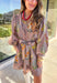 This mocha long sleeve dress by Entro captures all the warmth and charm of fall. Featuring a botanical floral print in rich autumn shades, it’s designed with a flattering v-neckline and a self-tie belt to define the waist. Side pockets and a full lining make it as practical as it is stylish, while the soft cotton fabric keeps it comfortable all day long. A perfect go-to for weekend plans, fall photos, or seasonal get-togethers.