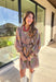 This mocha long sleeve dress by Entro captures all the warmth and charm of fall. Featuring a botanical floral print in rich autumn shades, it’s designed with a flattering v-neckline and a self-tie belt to define the waist. Side pockets and a full lining make it as practical as it is stylish, while the soft cotton fabric keeps it comfortable all day long. A perfect go-to for weekend plans, fall photos, or seasonal get-togethers.