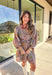 This mocha long sleeve dress by Entro captures all the warmth and charm of fall. Featuring a botanical floral print in rich autumn shades, it’s designed with a flattering v-neckline and a self-tie belt to define the waist. Side pockets and a full lining make it as practical as it is stylish, while the soft cotton fabric keeps it comfortable all day long. A perfect go-to for weekend plans, fall photos, or seasonal get-togethers.