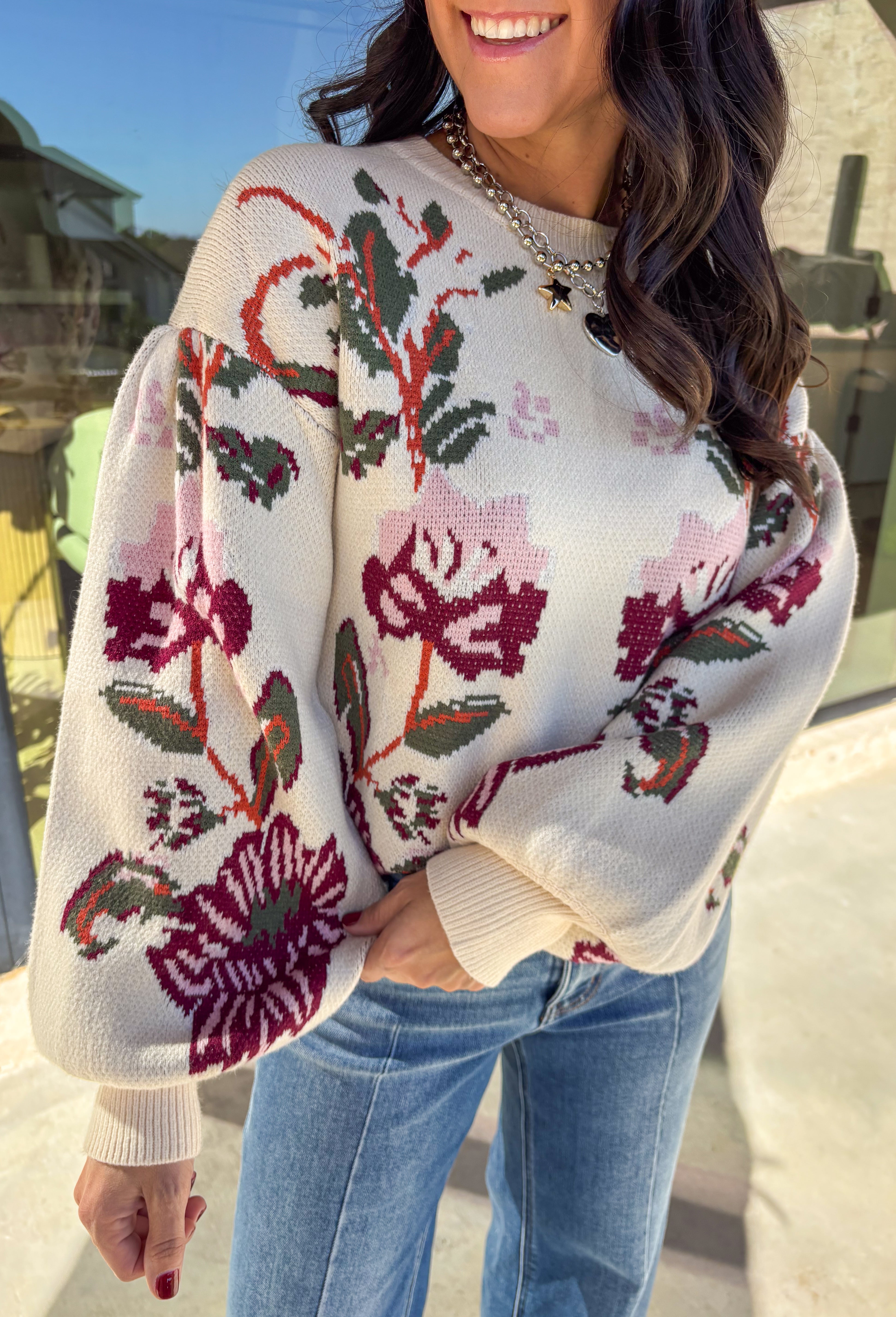 Bring a touch of warmth and charm to your winter wardrobe with this floral knit sweater by Voy. Designed in a soft cream base with blooms of hunter green, rust, burgundy, and light pink, this cozy knit perfectly captures the beauty of the season. The balloon sleeves add a stylish, relaxed shape, making it a perfect choice for everything from casual days to cozy evenings by the fire.