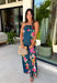 Make an unforgettable entrance in this stunning satin midi dress! The rich dark teal color creates the perfect backdrop for the vibrant floral print that blooms along each side in shades of pink, purple, green, yellow, red, and blue. The strapless neckline gives it an effortlessly elegant feel, while the smooth satin fabric adds a beautiful touch of shine. 