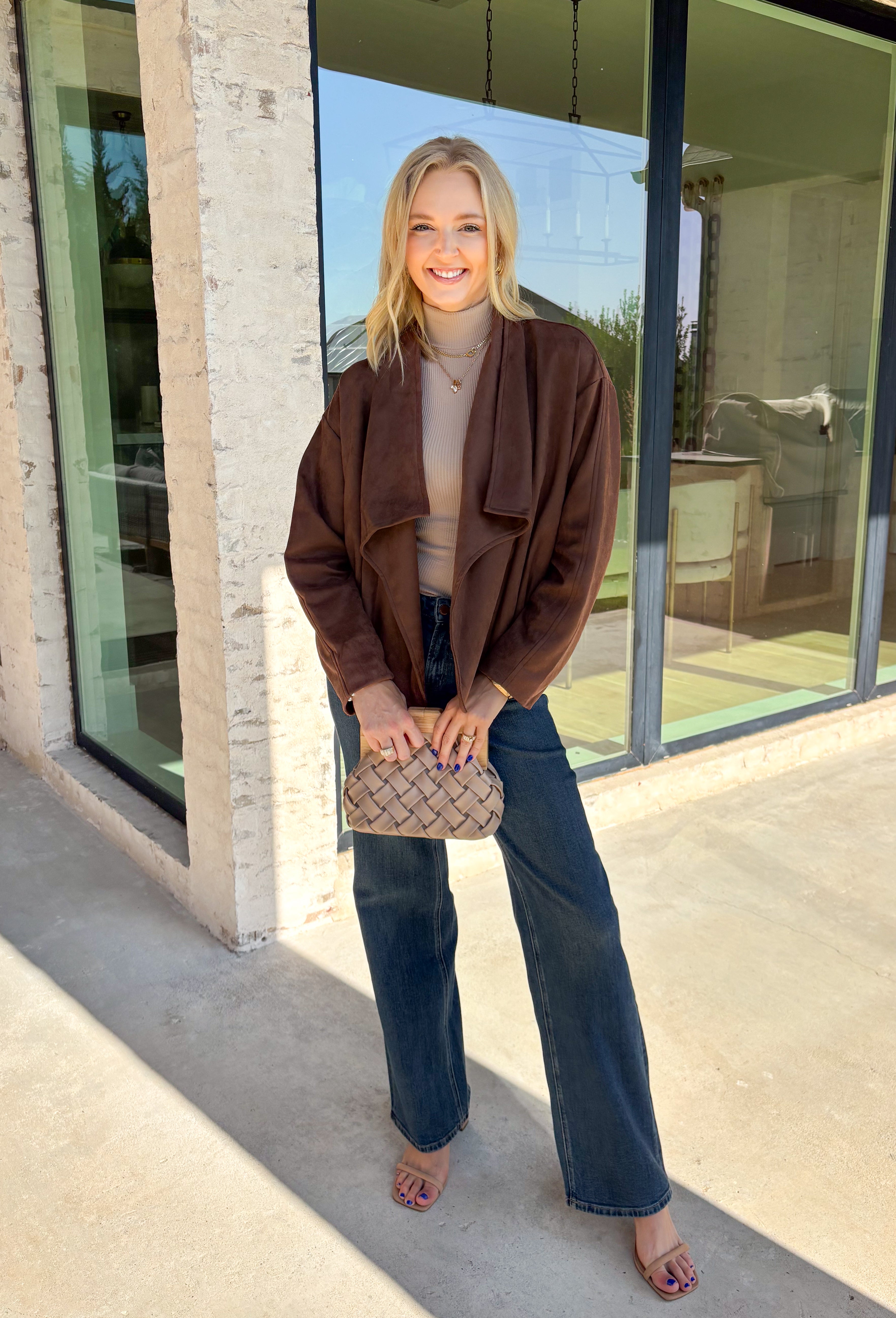 Elevate your layering game with this effortlessly chic faux suede jacket from Entro. Designed in a rich brown hue, this open-front jacket features a beautifully draped lapel that creates an elegant, flattering silhouette. The soft faux suede texture gives it a luxurious feel, while the comfortable stretch fabric makes it easy to wear from morning to night. Whether layered over dresses, blouses, or your favorite sweater, this timeless jacket is the perfect finishing touch for all your fall outfits.