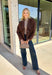 Elevate your layering game with this effortlessly chic faux suede jacket from Entro. Designed in a rich brown hue, this open-front jacket features a beautifully draped lapel that creates an elegant, flattering silhouette. The soft faux suede texture gives it a luxurious feel, while the comfortable stretch fabric makes it easy to wear from morning to night. Whether layered over dresses, blouses, or your favorite sweater, this timeless jacket is the perfect finishing touch for all your fall outfits.